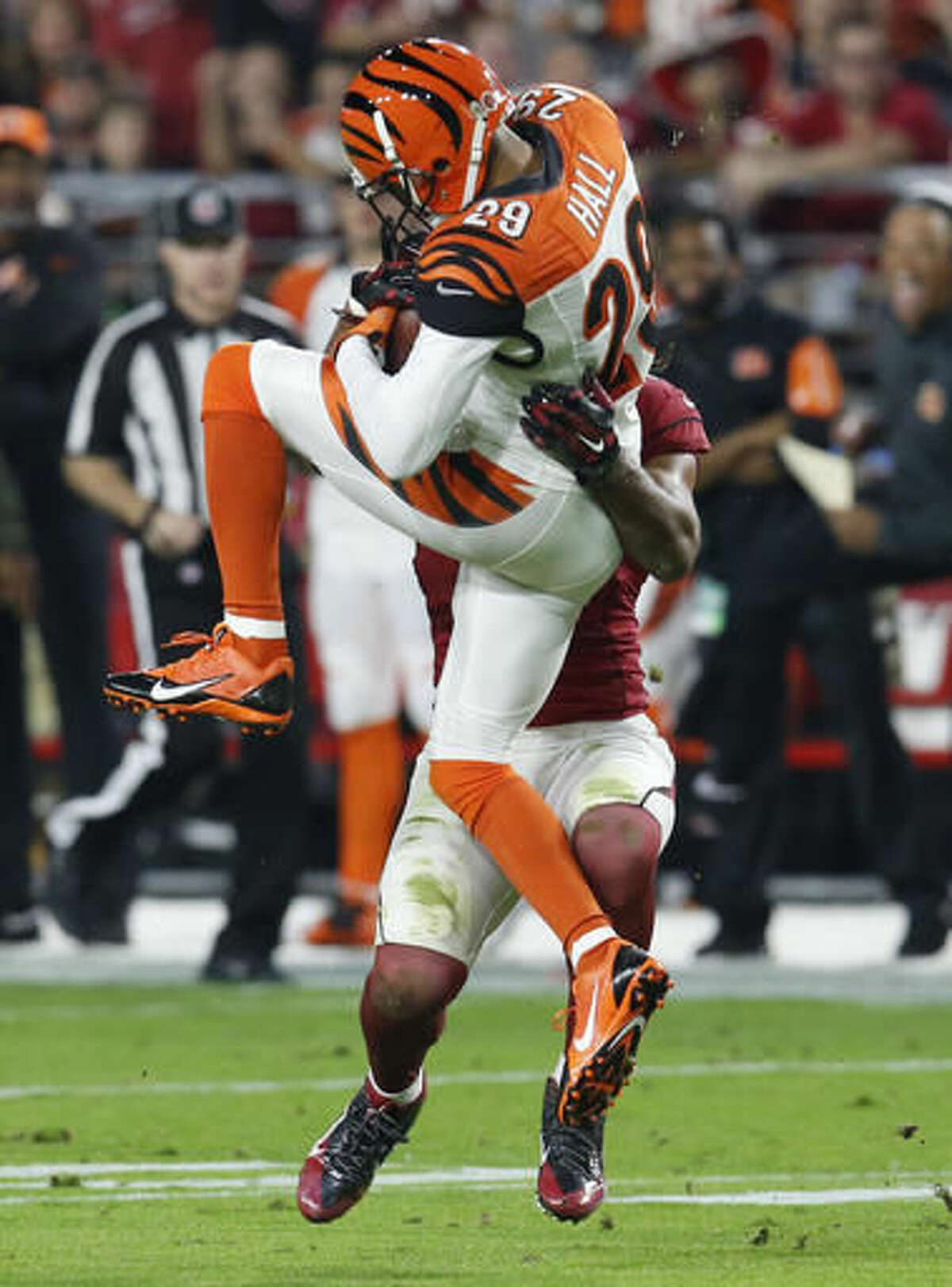 FILE - In this Nov. 22, 2015, file photo, Cincinnati Bengals strong safety Leon Hall (29) intercepts a pass intended for Arizona Cardinals wide receiver Larry Fitzgerald (11) during the first half of an NFL football game, in Glendale, Ariz. The New York Giants have signed cornerback Leon Hall, giving them a veteran who knows how to play in the slot in passing situations. The Giants announced the signing Thursday, Aug. 4, 2016. (AP Photo/Rick Scuteri, File)