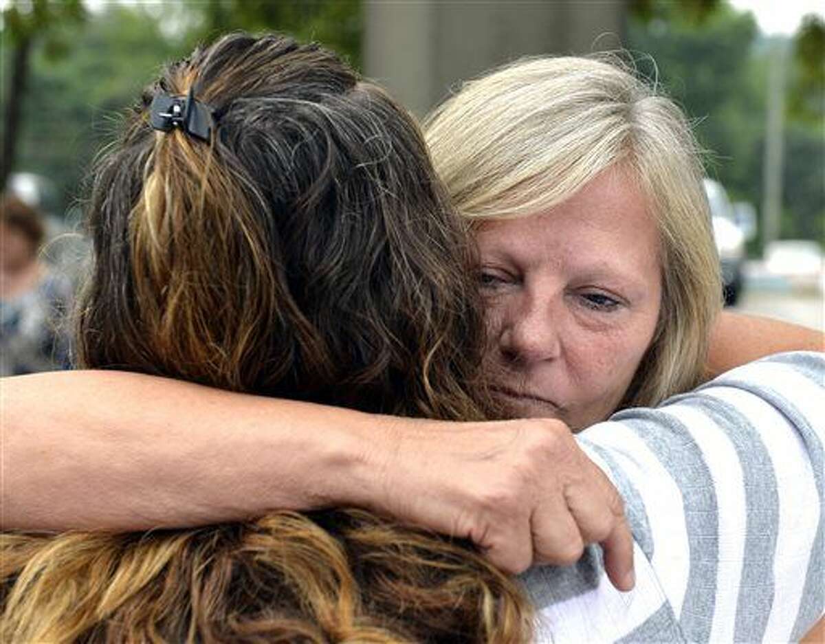 Ginny Peak, right, sister of Garr Keith Hardin embraces a family member following court proceedings, Thursday, Aug. 4, 2016 at the Meade County Courthouse in Brandenburg Ky. A Kentucky judge is considering whether Garr Keith Hardin and Jeffrey Dewayne Clark should be let out of jail after spending more than 20 years in prison before their murder convictions in what prosecutors called a "satanic" killing were vacated. (AP Photo/Timothy D. Easley)