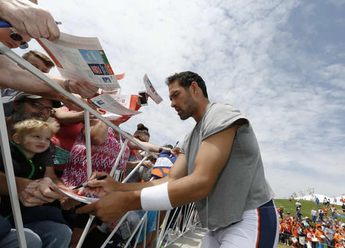 Denver Broncos quarterback Mark Sanchez signs autographs for fans following the team's NFL football training camp Thursday, Aug. 4, 2016 in Englewood, Colo. (AP Photo/David Zalubowski)