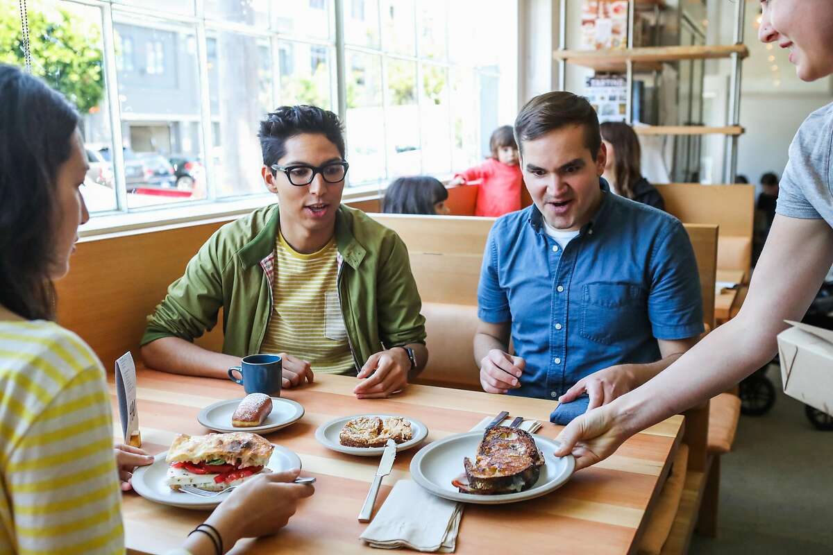 Stephanie Saffouri (left), Elijah Ball (center) and Thomas Dude (right) are served their lunch at Tartine Manufactory in San Francisco, California, on Wednesday, Aug. 17, 2016.