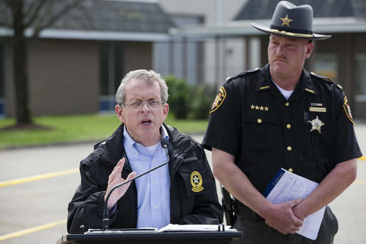 FILE - In this April 27, 2016, file photo, Ohio Attorney General Mike DeWine, left, and Pike County Sheriff Charles Reader, right, discuss the slayings of seven adults and a 16-year-old boy from the Rhoden family found shot April 22, 2016, at four properties near Piketon, Ohio, during a news conference in Waverly, Ohio. A spokesman for Ohio Attorney General Mike DeWine confirmed Thursday, Aug. 4, 2016, that investigators are working under the theory it wasn't a single attacker, and The Columbus Dispatch reports Pike County Sheriff Charles Reader referenced the suspicion of multiple "killers" during a Thursday, Aug. 4, 2016, court hearing related to custody of two of the three children who weren't harmed in the attack. (AP Photo/John Minchillo, File)