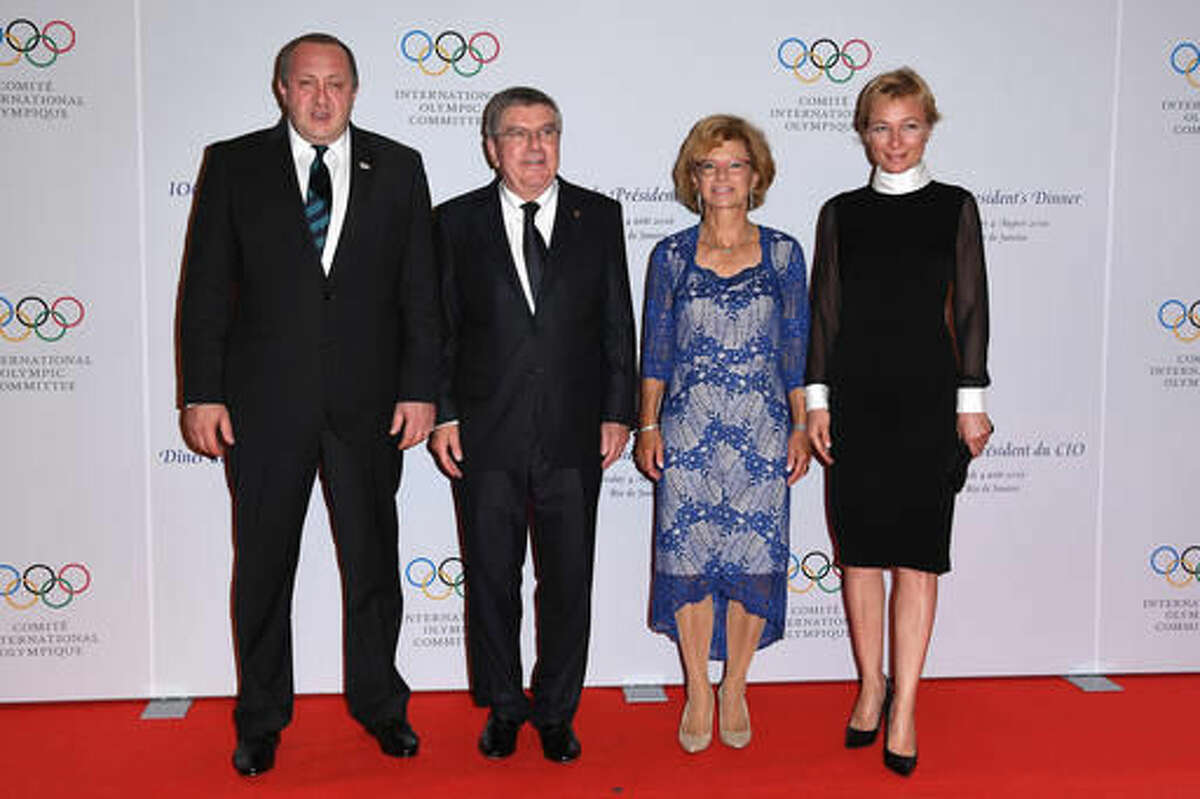 President of Georgia, Giorgi Margvelashvili, left, and his wife Maka Chichua, right, stand with International Olympic Committee President Thomas Bach and his wife Claudia Bach during a photo opportunity as they arrive for the Presidents' dinner at the Windsor convention center, ahead of the Summer Olympics in Rio de Janeiro, Brazil, late Thursday, Aug. 4, 2016. The Games opening ceremony is Friday. (Pascal Le Segretain/Pool Photo via AP)