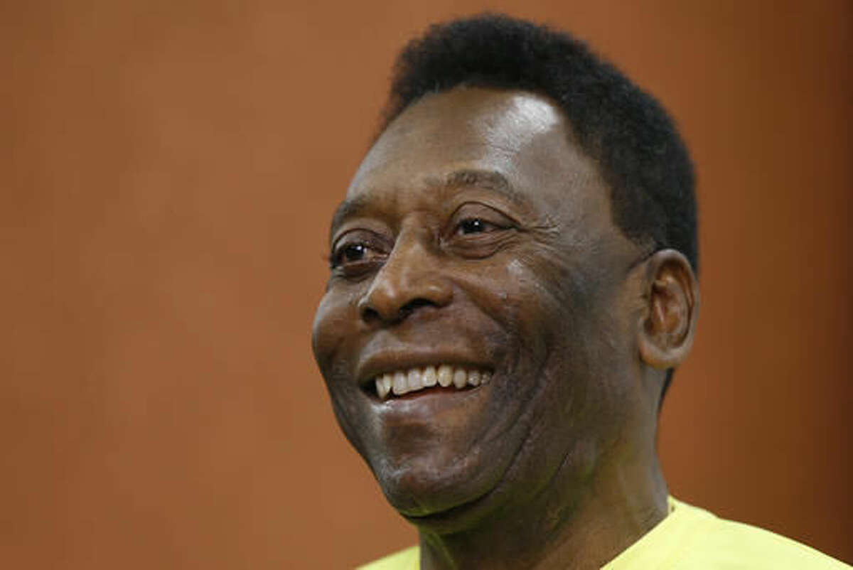 FILE - In this March 20, 2015 file photo, Brazilian soccer legend Pele smiles during a media opportunity at a restaurant in London. Pele said on Friday, Aug. 5, 2016 that his poor health will keep him from attending the opening ceremony of the Rio Olympics. (AP Photo/Kirsty Wigglesworth, File)