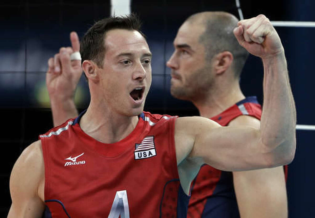 FILE - In this Aug. 4, 2012, file photo, David Lee, of the United States, front, and teammate Clayton Stanley celebrate during a men's preliminary volleyball match against Russia at the 2012 Summer Olympics, in London. Lee debated whether to even march in another opening ceremony. He has done the Olympic pomp-and-circumstance thing a few times now. Then he realized how much he needed to be there at Maracana Stadium to take part in the festivities alongside his teammates, eight of whom have never been to an Olympics prior to Rio. (AP Photo/Jeff Roberson, File)