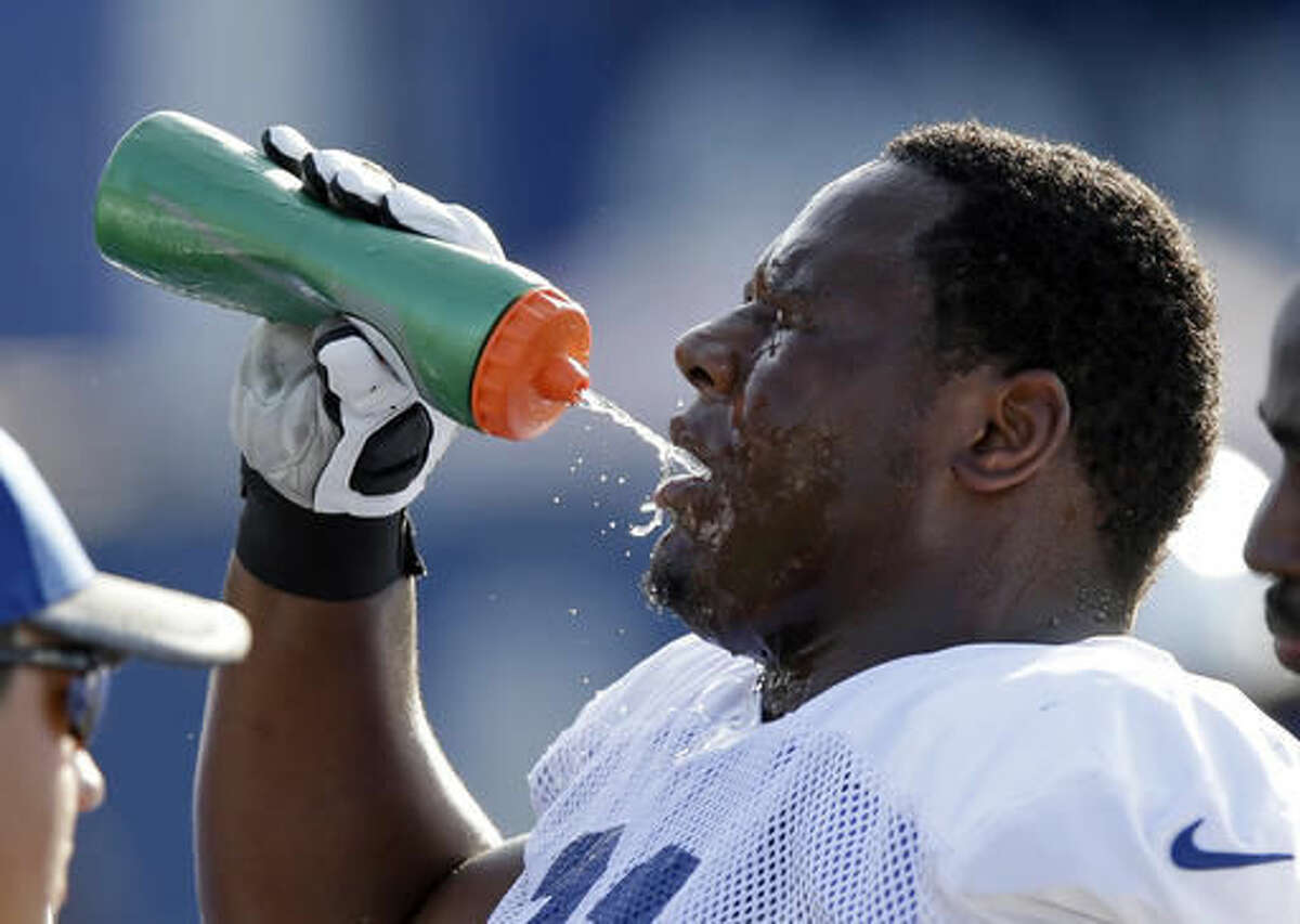 Indianapolis Colts defensive lineman Hassan Ridgeway takes a drink of water during the NFL team's football training camp in Anderson, Ind., Tuesday, Aug. 2, 2016. (AP Photo/Michael Conroy)