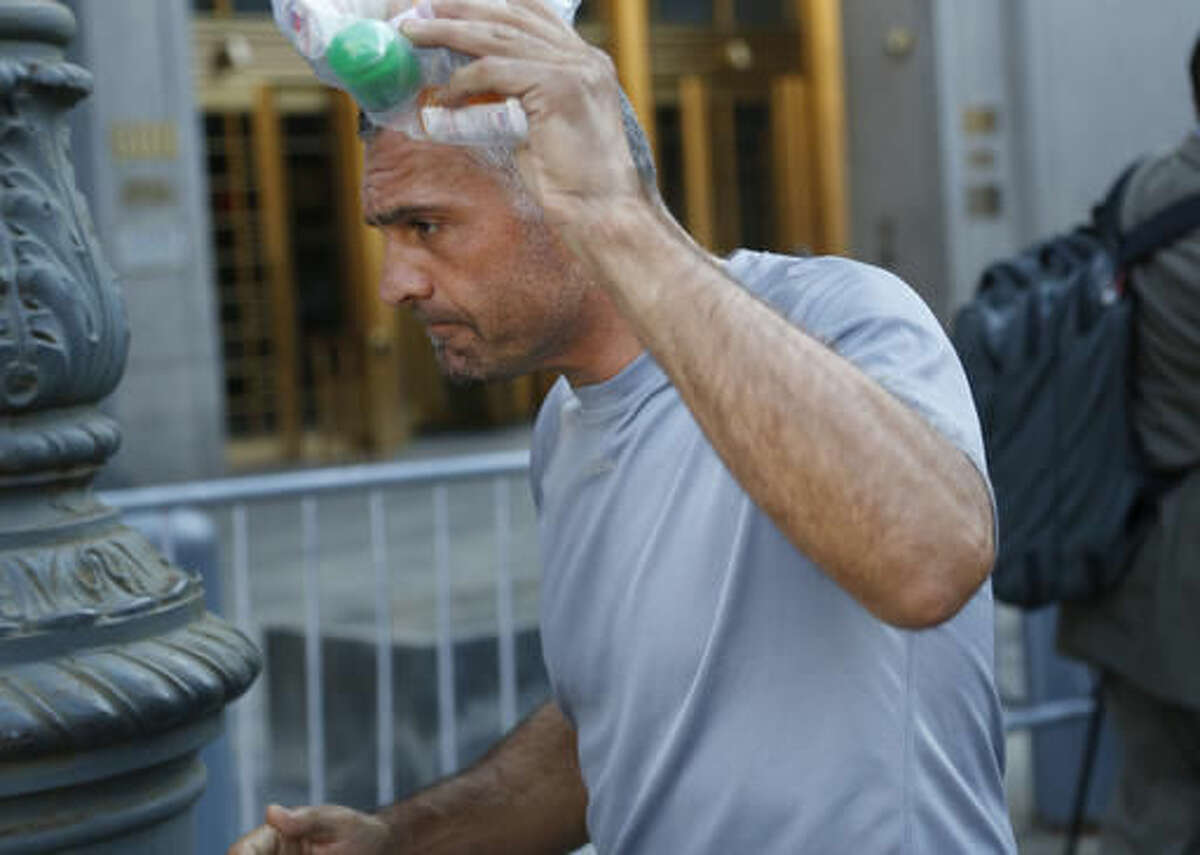 Anthony Cassetta tries to cover his face as he leaves federal court in New York, Thursday, Aug. 4, 2016. Declaring that the Mafia is not just the stuff of movie scripts, federal prosecutors charged nearly four dozen people Thursday with being part of an East Coast crime syndicate, including an old-school mobster in New York and a reputed mob chieftain in Philadelphia who has been pursued by the government for decades. (AP Photo/Seth Wenig)