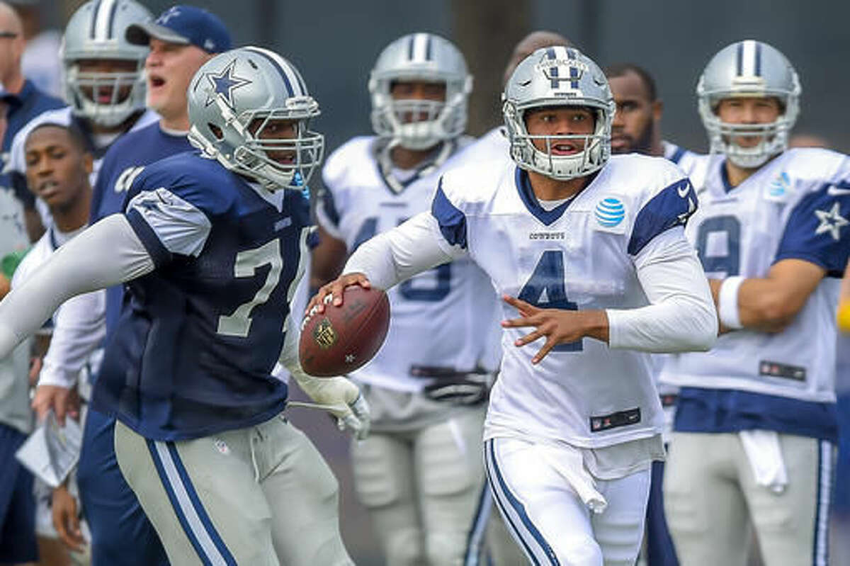 FILE - In this Monday, Aug. 1, 2016 photo, Dallas Cowboys defensive end Lawrence Okoye (74) rushes quarterback Dak Prescott (4) as he attempts to get a pass off during Dallas Cowboys' NFL football training camp in Oxnard, Calif. The Cowboys will give longer looks to a pair of young players with no NFL experience: rookie fourth-round pick Dak Prescott and second-year player Jameill Showers, who spent most of last season on the practice squad. (AP Photo/Gus Ruelas, File)