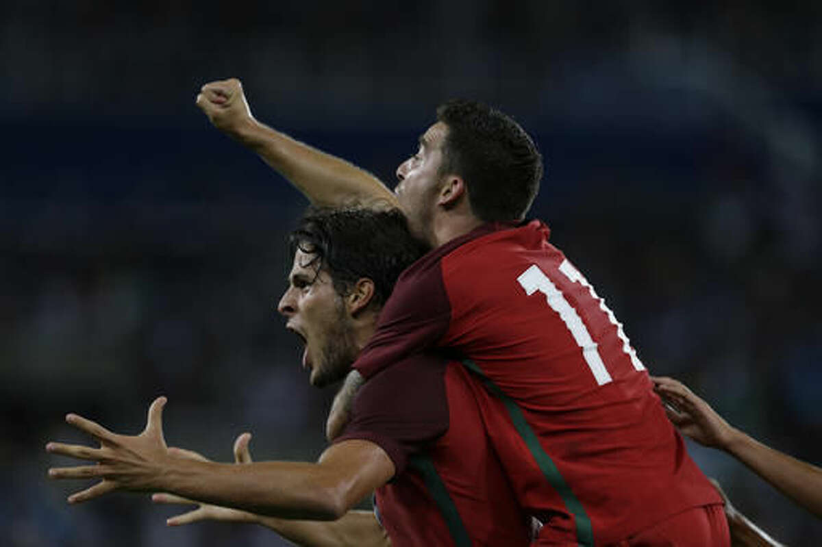 Portugal's Paciencia, bottom, celebrates scoring his side's first goal with his teammate Salvador Agra during a group D match of the men's Olympic football tournament between Portugal and Argentina at the Rio Olympic Stadium in Rio De Janeiro, Brazil, Thursday, Aug. 4, 2016. Portugal won 2-0. (AP Photo/Leo Correa)