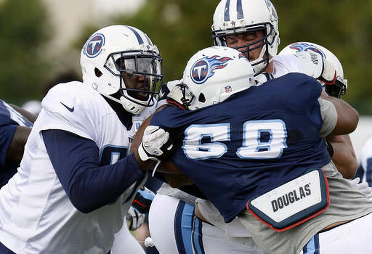 Tennessee Titans offensive guard Quinton Spain, left, blocks defensive end Mehdi Abdesmad (68) during a play at the team's NFL football training camp Thursday, Aug. 4, 2016, in Nashville, Tenn. (AP Photo/Mark Zaleski)