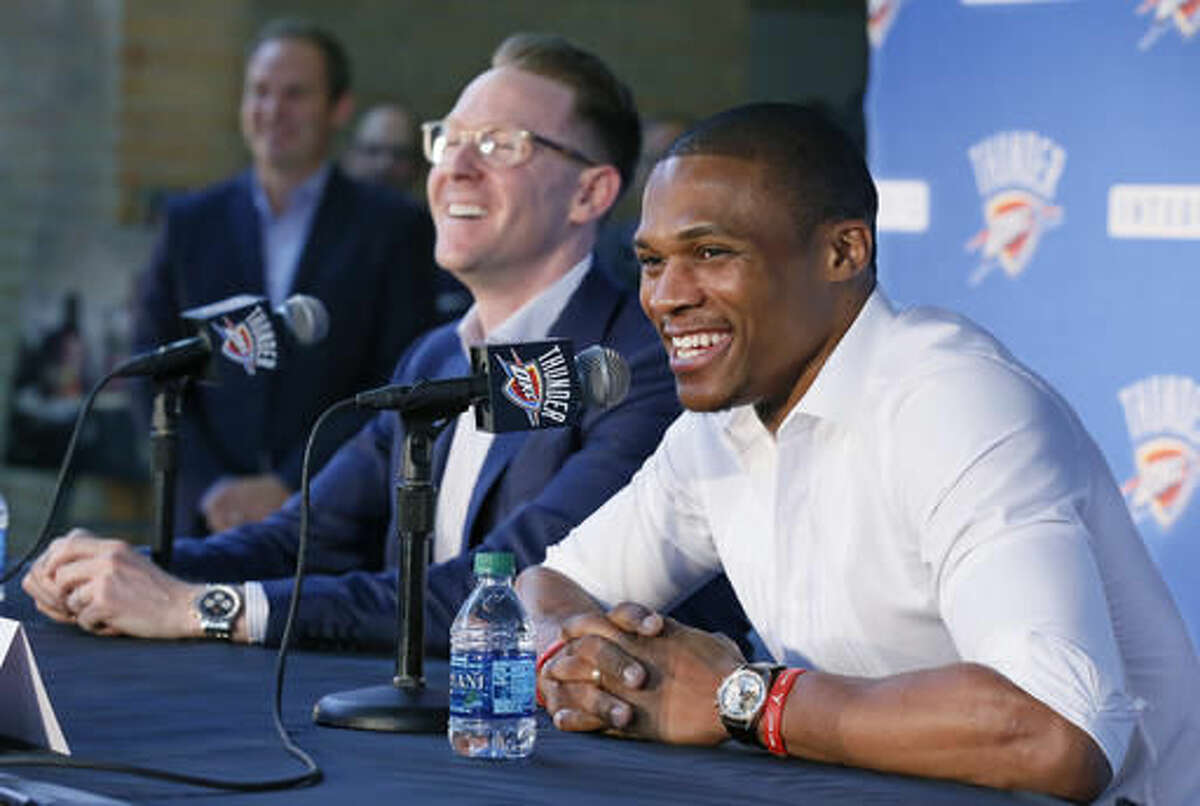 Oklahoma City Thunder guard Russell Westbrook, right, and Sam Presti, left, general manager, laugh during a news conference to announce that he has signed a contract extension with the Thunder, in Oklahoma City, Thursday, Aug. 4, 2016. (AP Photo/Sue Ogrocki)