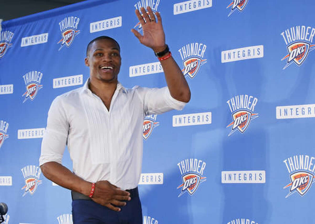 Oklahoma City Thunder guard Russell Westbrook waves as he arrives for a news conference to announce that he has signed a contract extension with the Thunder, in Oklahoma City, Thursday, Aug. 4, 2016. (AP Photo/Sue Ogrocki)
