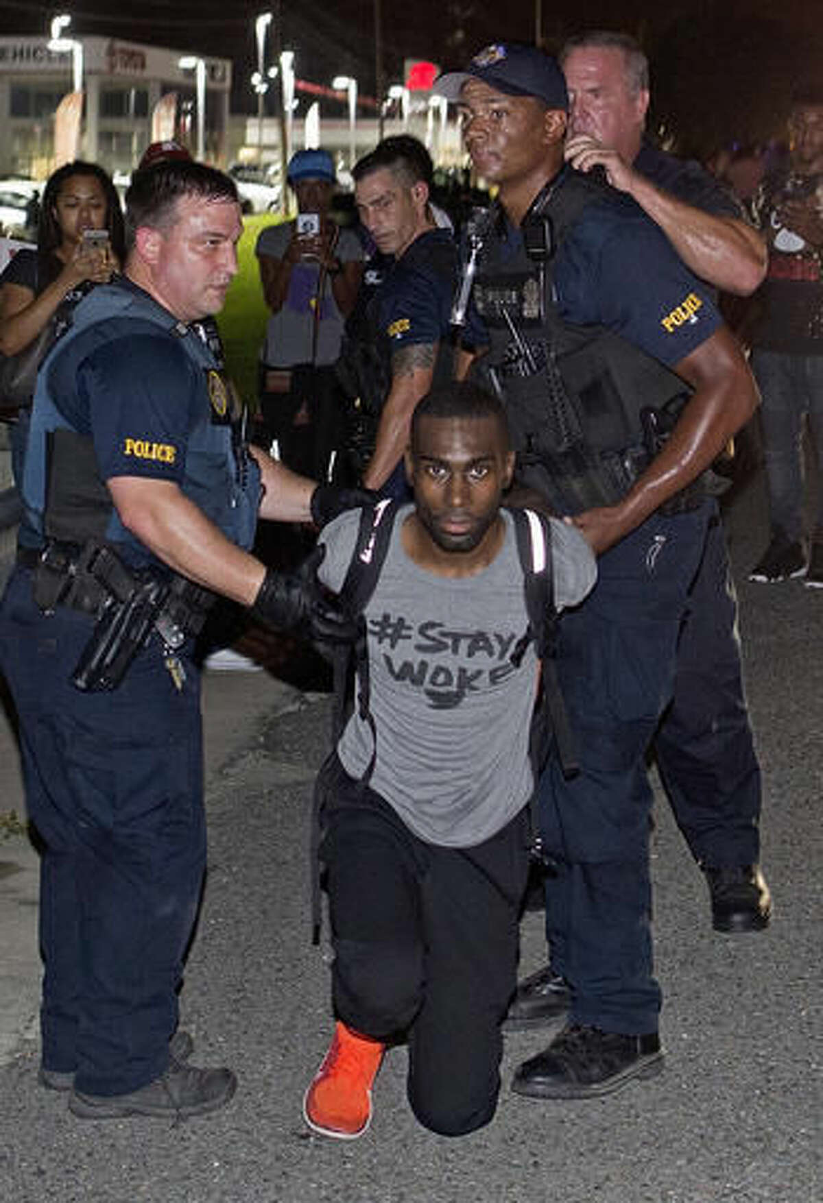 FILE - In this Saturday, July 9, 2016, file photo, police officers arrest activist DeRay McKesson during a protest along Airline Highway, a major road that passes in front of the Baton Rouge Police Department headquarters in Baton Rouge, La. Mckesson sued the city of Baton Rouge and police officials on Thursday, Aug. 4, 2016, saying officers responded in a "militarized and aggressive manner" in arresting him and other people protesting a police shooting death. (AP Photo/Max Becherer, File)