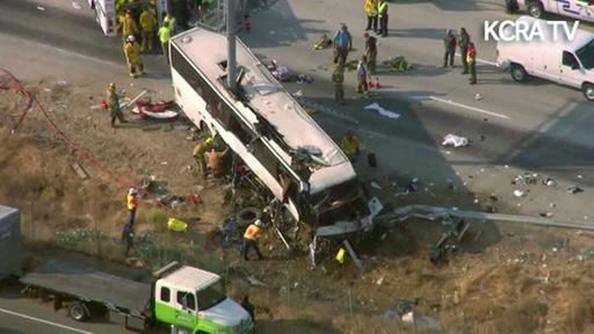 This still frame from video provided by KCRA3-TV shows authorities investigating the scene of a charter bus crash on northbound Highway 99 between Atwater and Livingston, Calif., Tuesday, Aug. 2, 2016. The bus veered off the central California freeway before dawn Tuesday and struck a pole that sliced the vehicle nearly in half, authorities said. (KCRA3-TV via AP) MANDATORY CREDIT TV OUT
