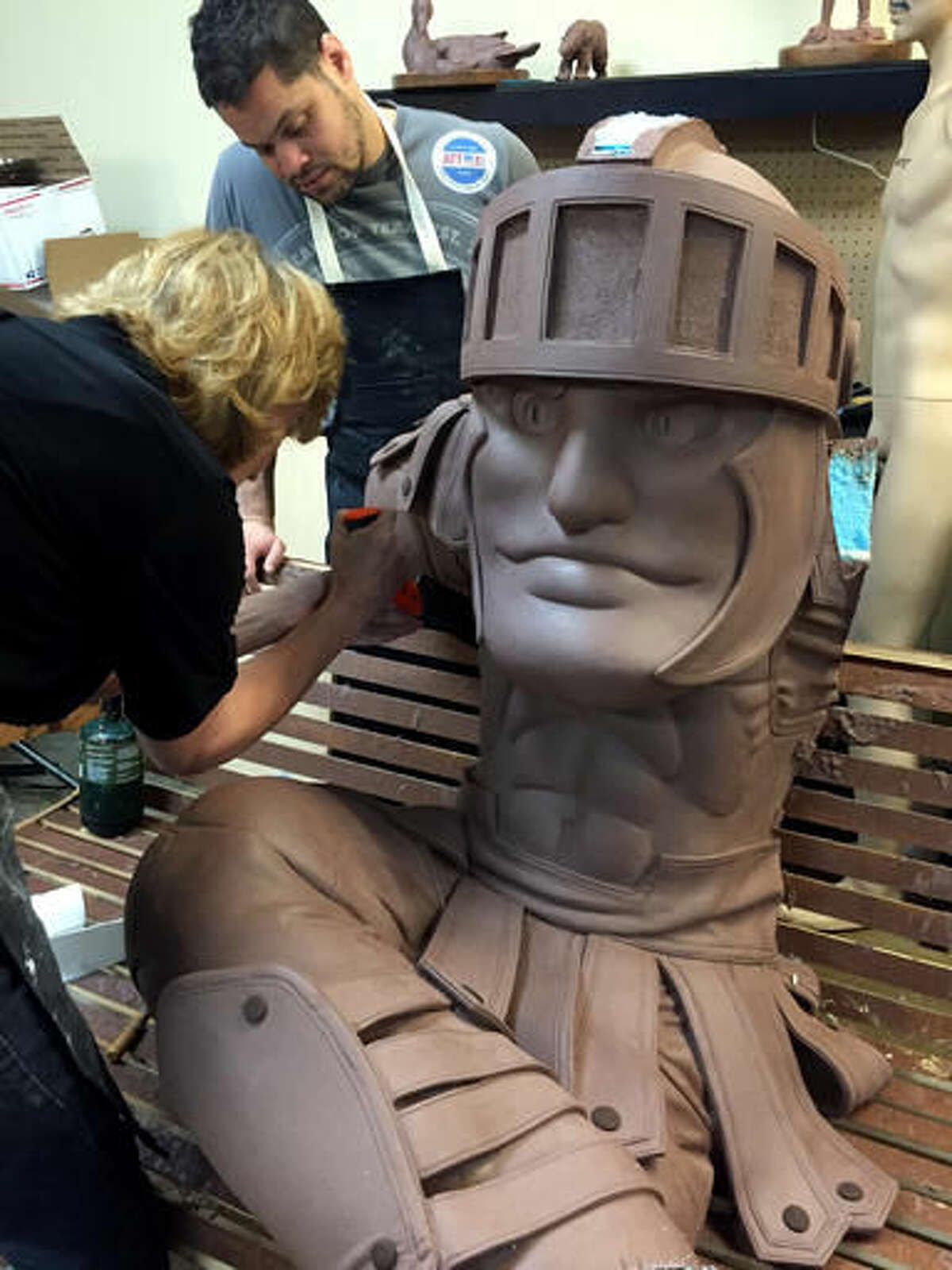 This Aug. 1, 2016, photo provided by Dugan Strategic Marketing shows construction of a clay rendering of a new bronze statue monument to Michigan State University's Sparty mascot, at the sculptor’s studio in Troutdale, Ore. A clay rendering will be used to cast the statue. Those involved in the project say an Oct. 12 unveiling is scheduled at the MSU Union in East Lansing, Mich. (Alison Brown/Dugan Strategic Marketing via AP)