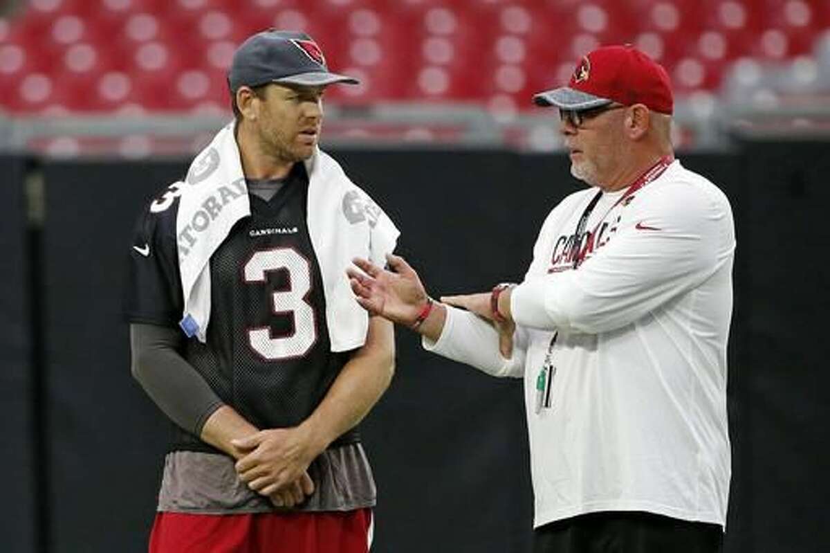 Arizona Cardinals head coach Bruce Arians, right, talks with starting quarterback Carson Palmer (3) during practice at the NFL football team's training camp Tuesday, Aug. 2, 2016, in Glendale, Ariz. (AP Photo/Ross D. Franklin)
