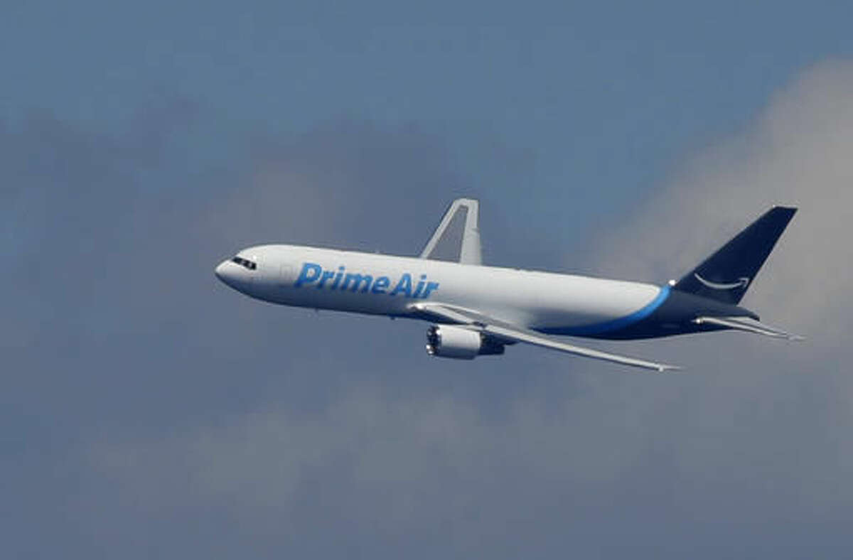 A Boeing 767 with an Amazon.com "Prime Air" livery flies over Lake Washington, Friday, Aug. 5, 2016, as part of the Boeing Seafair Air Show. Amazon unveiled its first branded cargo plane Thursday, one of 40 freighters that will make up the company's own air transportation network of 40 Boeing jets leased from Atlas Air and Air Transportation Services Group, which will operate the air cargo network. (AP Photo/Ted S. Warren)