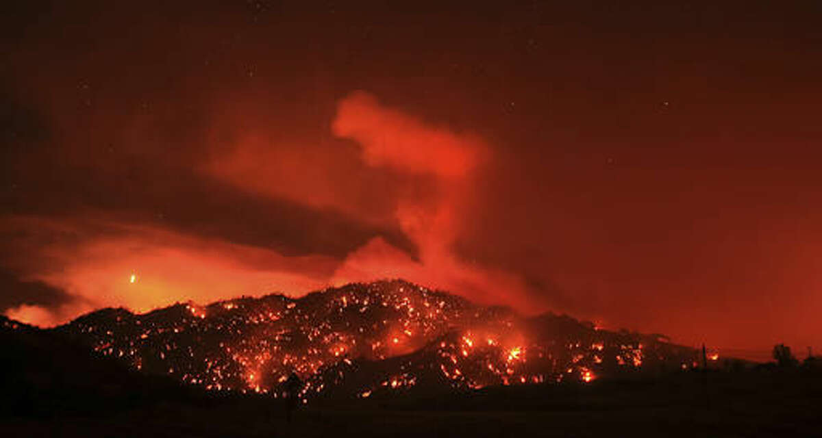 In this Tuesday, Aug. 2, 2016 photo, the Cold fire burns at night by the Solano and Napa County line near Lake Berryessa, Calif. (Kent Porter/The Press Democrat via AP)