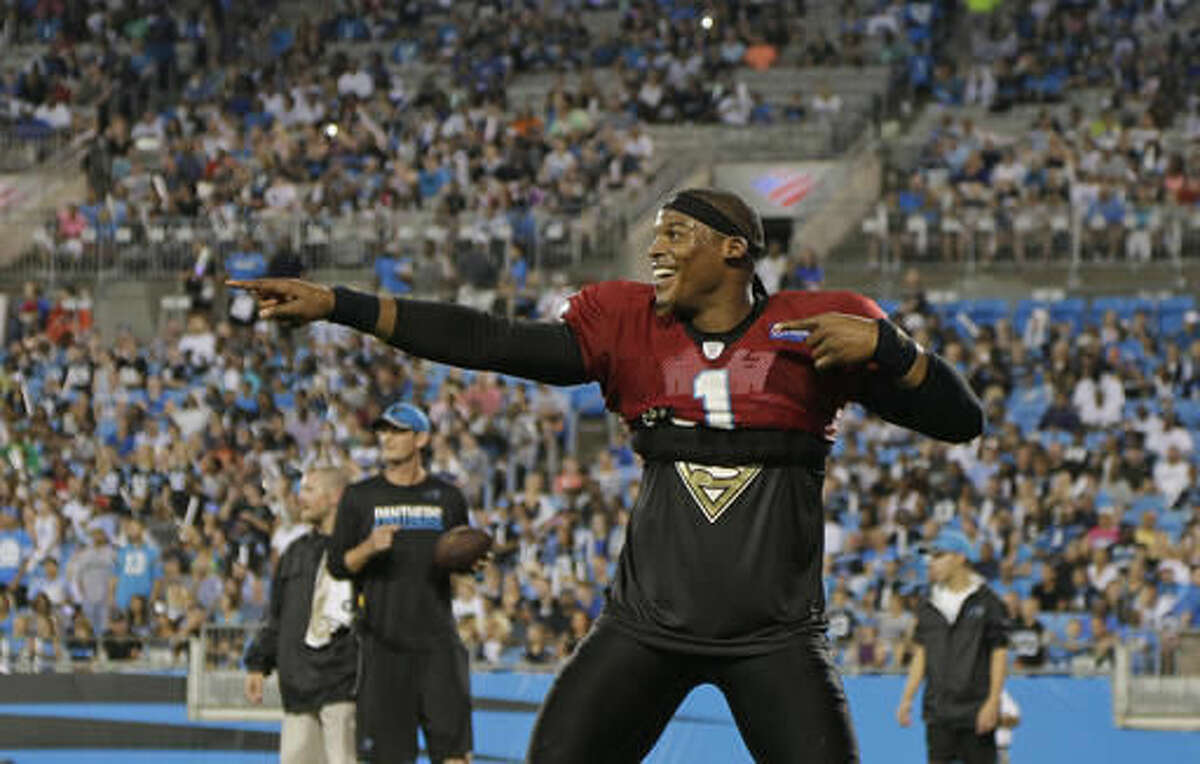 Carolina Panthers' Cam Newton encourages the crowd at the team's annual Fan Fest practice, during NFL training camp in Charlotte, N.C., Friday, Aug. 5, 2016. (AP Photo/Chuck Burton)