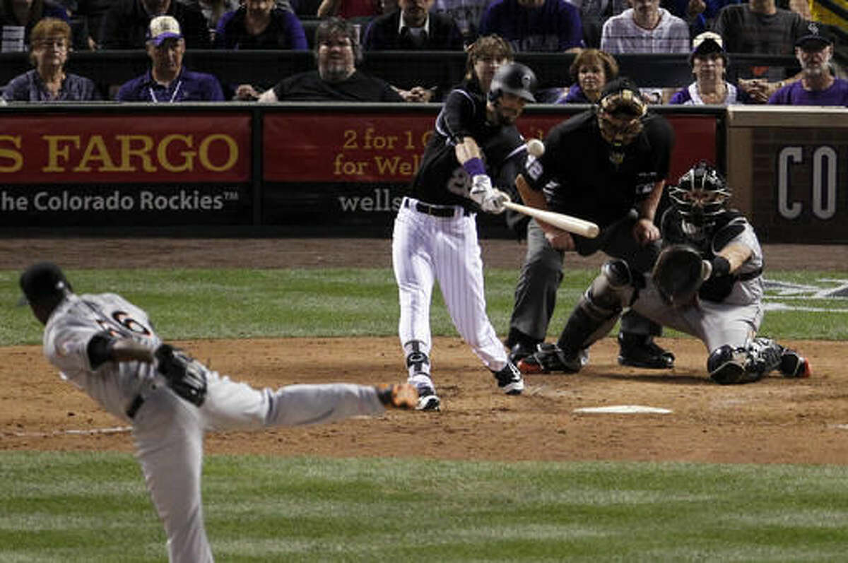 Colorado Rockies' David Dahl (26) hits an RBI double off Miami Marlins relief pitcher Fernando Rodney during the eighth inning of a baseball game in Denver on Friday, Aug. 5, 2016. (AP Photo/Joe Mahoney)