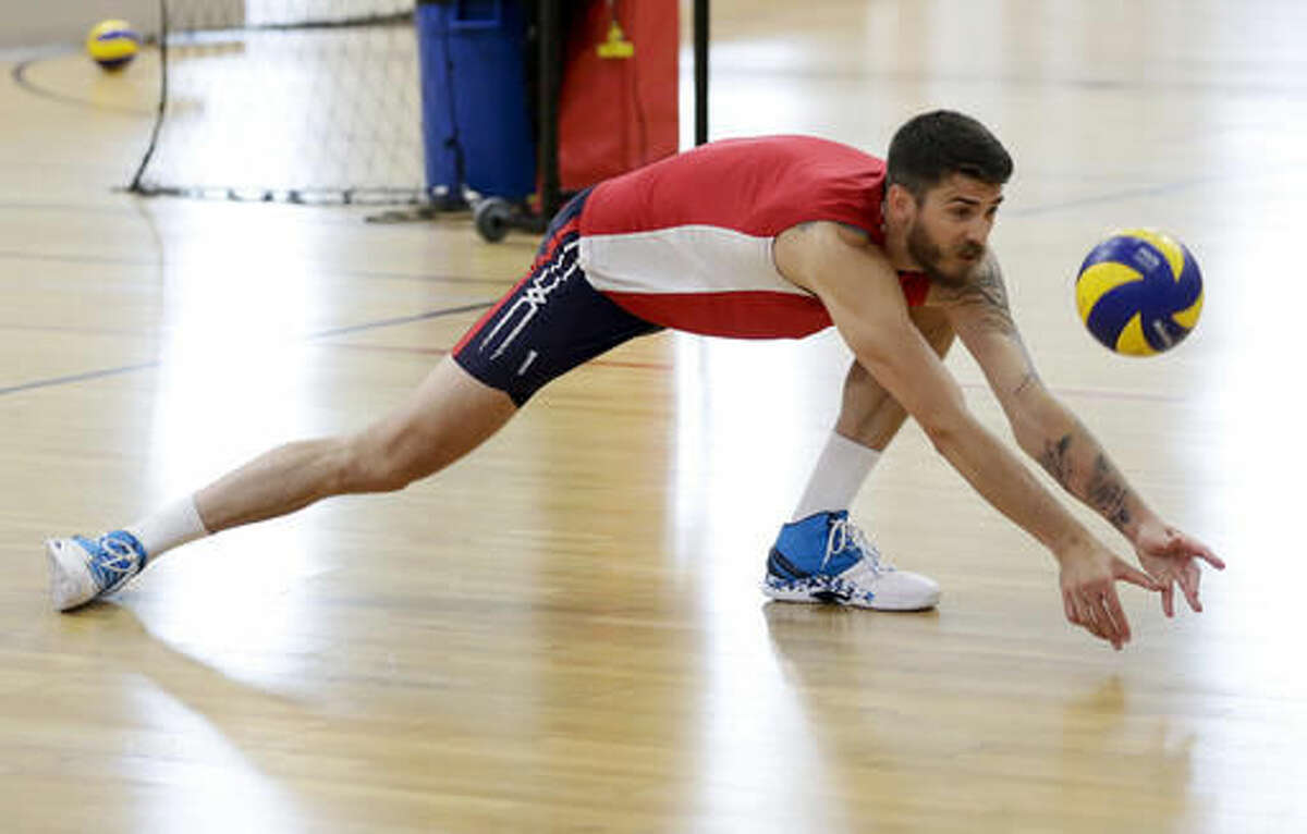 In this May 25, 2016 photo, Olympic volleyball player Matt Anderson, of the United States, lunges for a ball during practice, in Anaheim, Calif. In late 2014, Anderson found himself in a deep funk and made that daunting decision to step away from volleyball to find himself. Eventually, he found his way back, and Anderson will lead the Americans into their Olympic opener Sunday, Aug. 7, against Canada. (AP Photo/Chris Carlson)