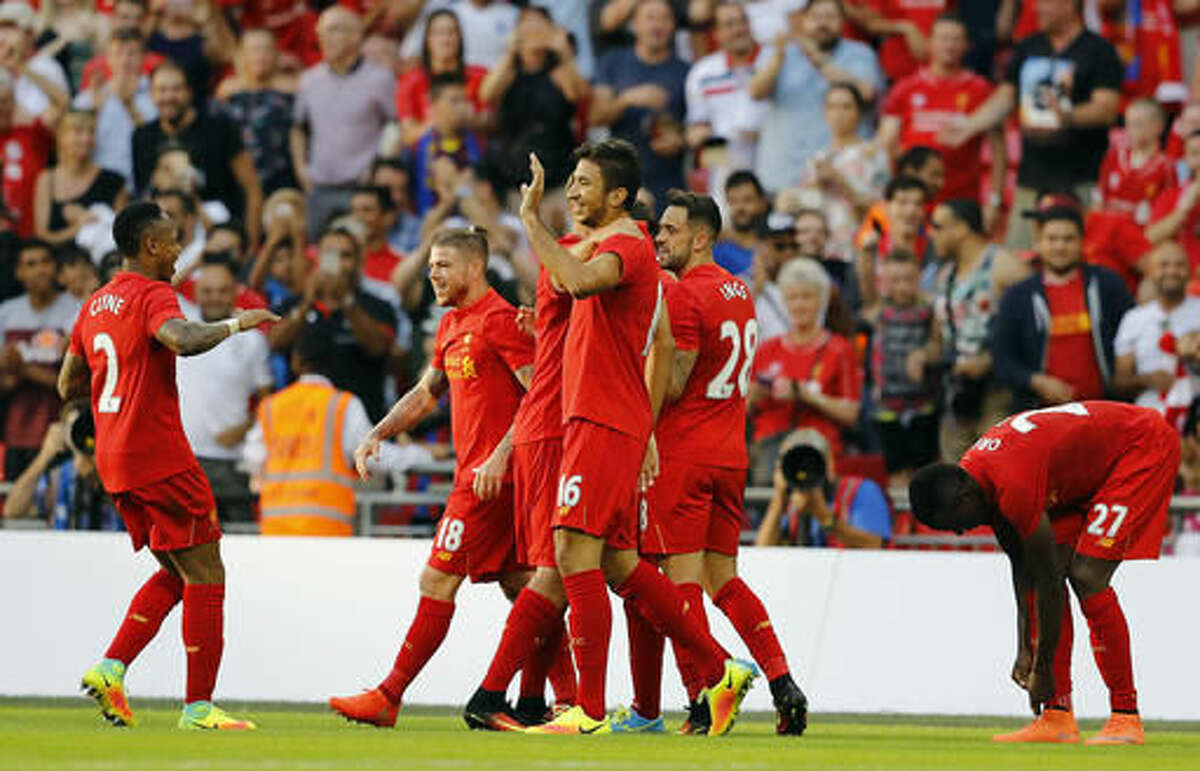 Liverpool teammates celebrate after a goal was scored, during the International Champions Cup soccer match between Liverpool and Barcelona at Wembley stadium in London, Saturday, Aug. 6, 2016. Liverpool won by 4-0. (AP Photo/Frank Augstein)