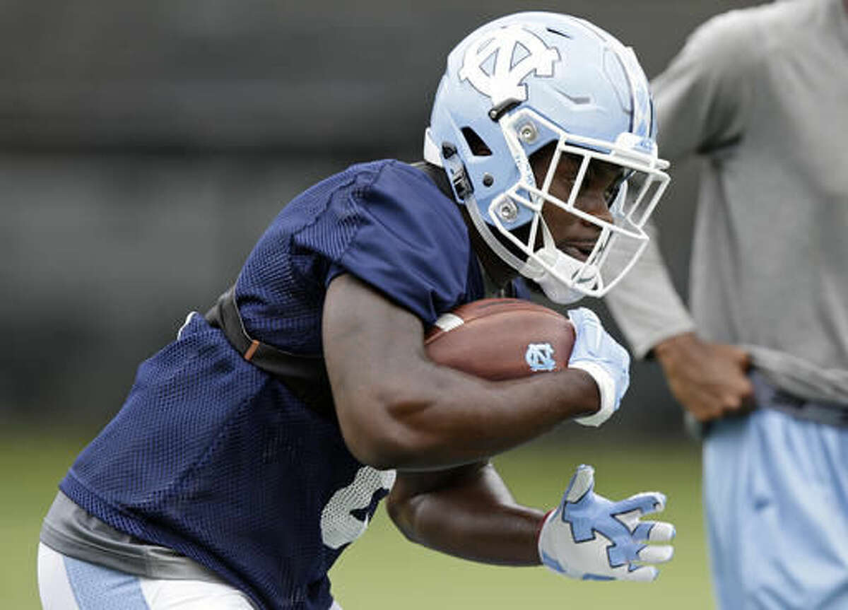 North Carolina tailback T.J. Logan carries the ball during the team's first NCAA college football practice of the season in Chapel Hill, N.C., Friday, Aug. 5, 2016. (AP Photo/Gerry Broome)