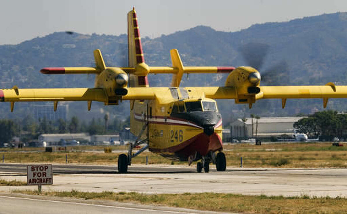 One of two Super Scooper firefighting aircraft arrive arrive on lease from Quebec, at the Van Nuys airport in Los Angeles on Saturday, Aug. 6, 2016. The large water tankers, which can carry up to 1,600 gallons of water, arrived about three weeks earlier than usual. They will be operational on Monday. (AP Photo/Richard Vogel)