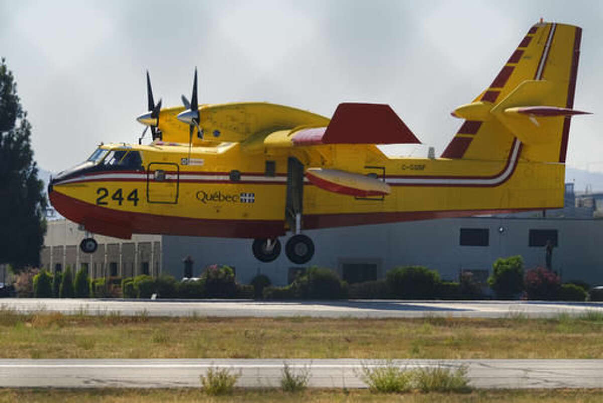 One of two Super Scooper firefighting aircrafts arrive on lease from Quebec to the Van Nuys airport in Los Angeles, Saturday, Aug. 6, 2016. The large water tankers, that can carry up to 1,600 gallons of water, arrived about three weeks earlier than usual. They will be operational on Monday. (AP Photo/Richard Vogel)