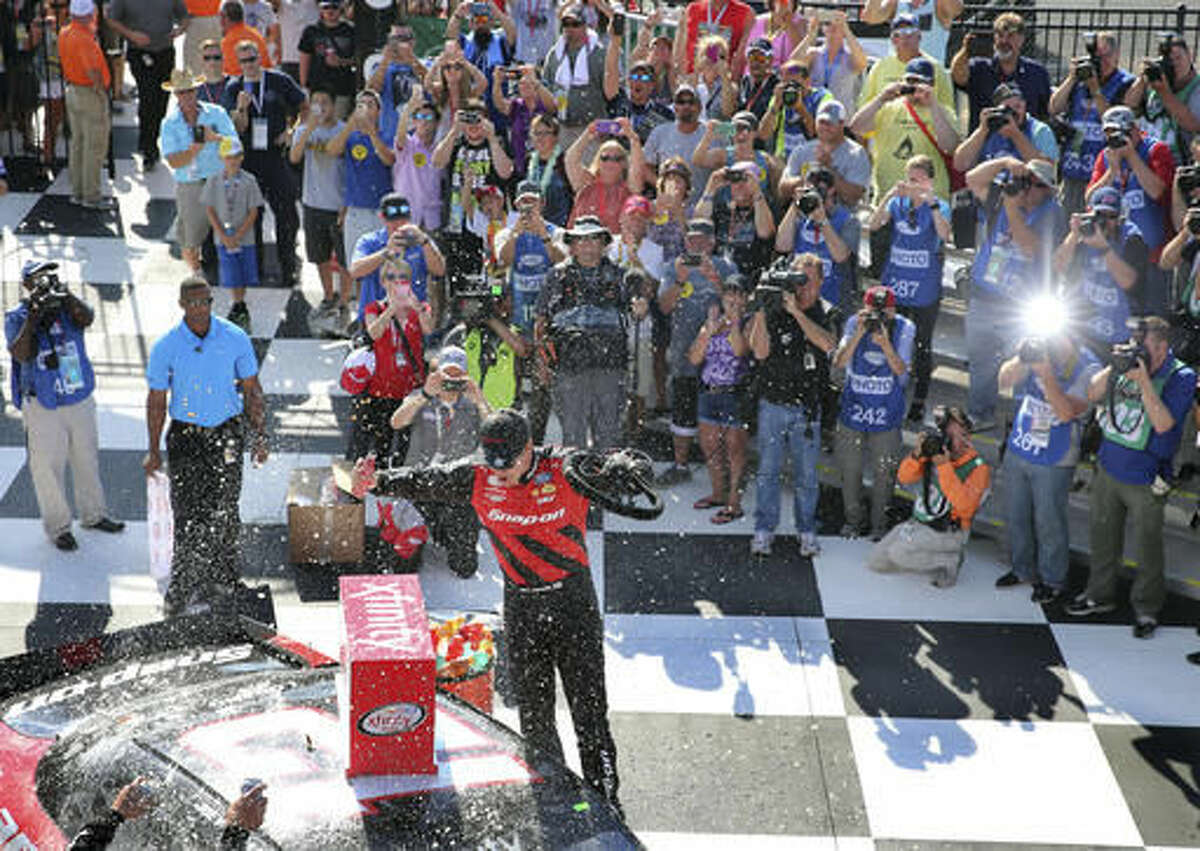 Joey Logano (12) celebrates in Victory Lane after winning the NASCAR Xfinity series auto race at Watkins Glen International, Saturday, Aug. 6, 2016, in Watkins Glen, N.Y. (AP Photo/Mel Evans)