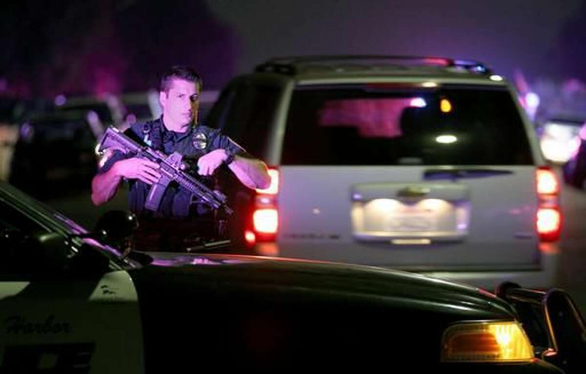 FILE - In this Thursday night, July 28, 2016, file photo, a San Diego Harbor Police officer helps to secure the scene in San Diego near where two San Diego Police officers were shot Thursday night. The critical moment when a gunman opened fire on two San Diego police officers, killing one, wasn't captured on the camera one of the officers was wearing because he didn't turn it on until after bullets flew. It's the latest example of the hole created by policies like San Diego's that allow officers to determine when to start recording. (John Gastaldo/The San Diego Union-Tribune via AP, File)