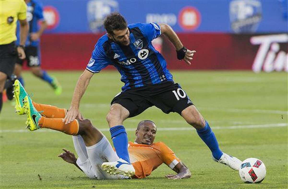 Montreal Impact's Ignacio Piatti (10) is challenged by Houston Dynamo's Ricardo Clark during first-half MLS soccer game action in Montreal, Saturday, Aug. 6, 2016. (Graham Hughes/The Canadian Press via AP)