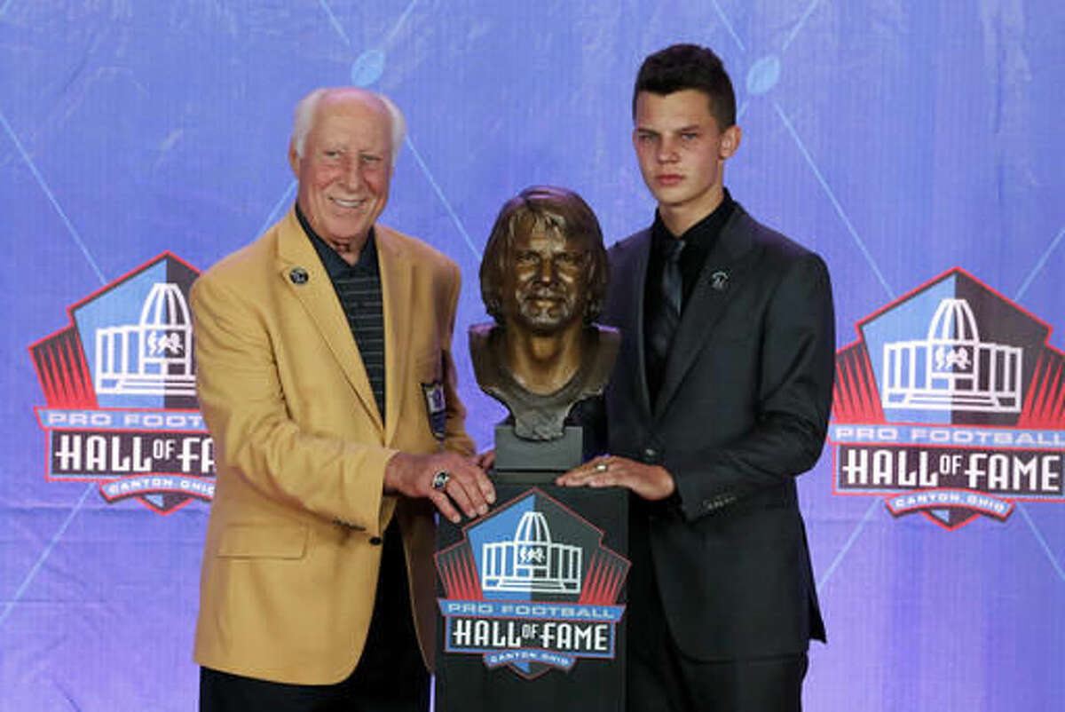 Hall of Fame NFL player Fred Biletnikoff, left, and Ken Stabler's grandson Justin Moyes pose with the bust of quarterback Stabler during an induction ceremony at the Pro Football Hall of Fame, Saturday, Aug. 6, 2016, in Canton, Ohio. (AP Photo/Gene J. Puskar)