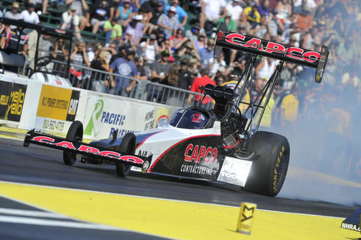 In this photo provided by NHRA, Steve Torrence makes a qualifying run in Top Fuel at the Protect the Harvest NHRA Nationals auto races Friday, Aug. 5, 2016, in Kent, Wash. Torrence took the Top Fuel lead with 3.701-seconds at 328.54 mph. (Teresa Long/NHRA via AP)