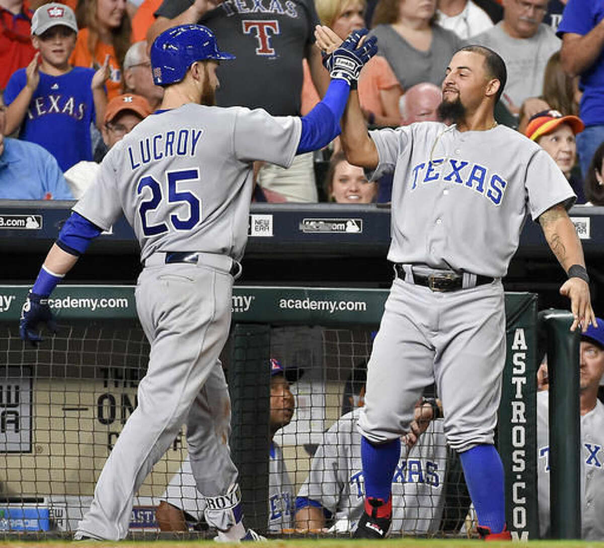 Texas Rangers' Jonathan Lucroy (25) celebrates his solo home run off Houston Astros' relief pitcher Tony Sipp with Rougned Odor in the eighth inning of a baseball game, Saturday, Aug. 6, 2016, in Houston. (AP Photo/Eric Christian Smith)