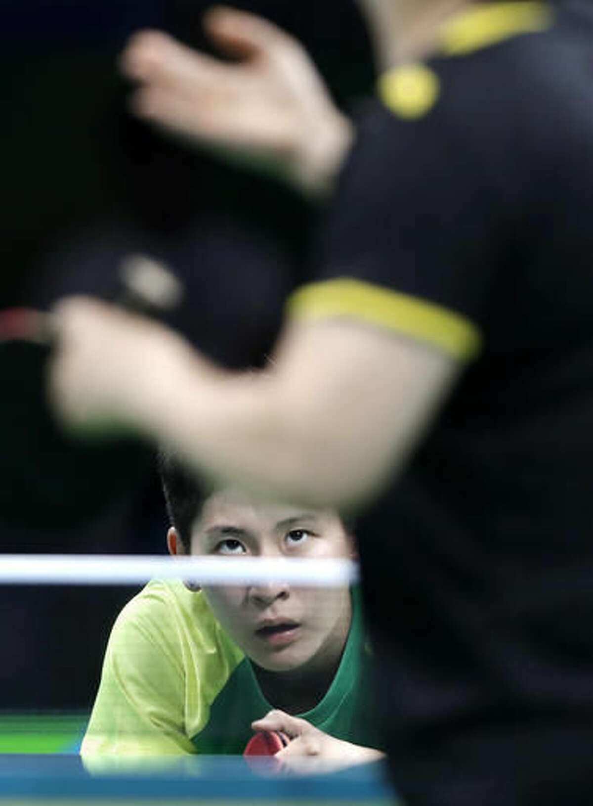 Caroline Kumahara, bottom, of Brazil, waits on the serve of Ni Xia Lian, of Luxembourg, during a table tennis match at the 2016 Summer Olympics in Rio de Janeiro, Brazil, Saturday, Aug. 6, 2016. (AP Photo/Petros Giannakouris)
