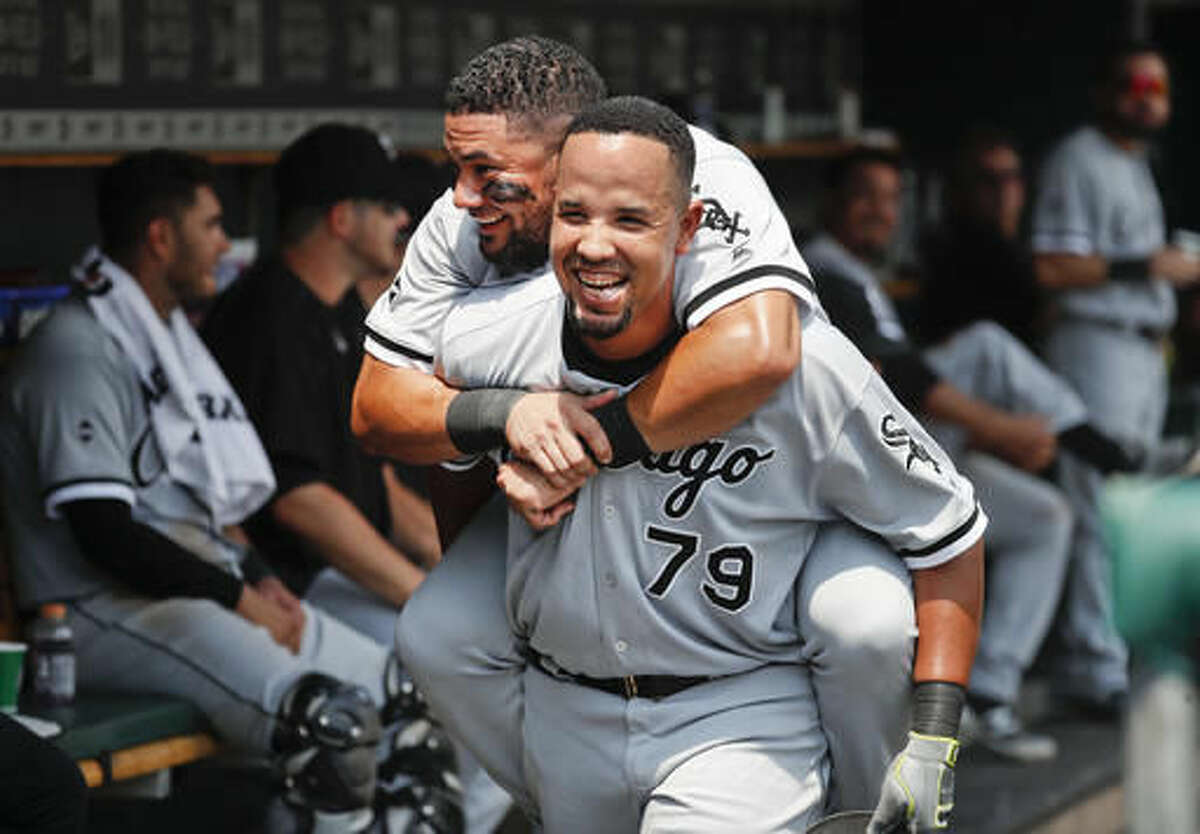 Chicago White Sox' s Jose Abreu (79) celebrates his two-run home run as Melky Cabrera rides on his back in the dugout against the Detroit Tigers in the second inning of a baseball game Thursday, Aug. 4, 2016 in Detroit. (AP Photo/Paul Sancya)