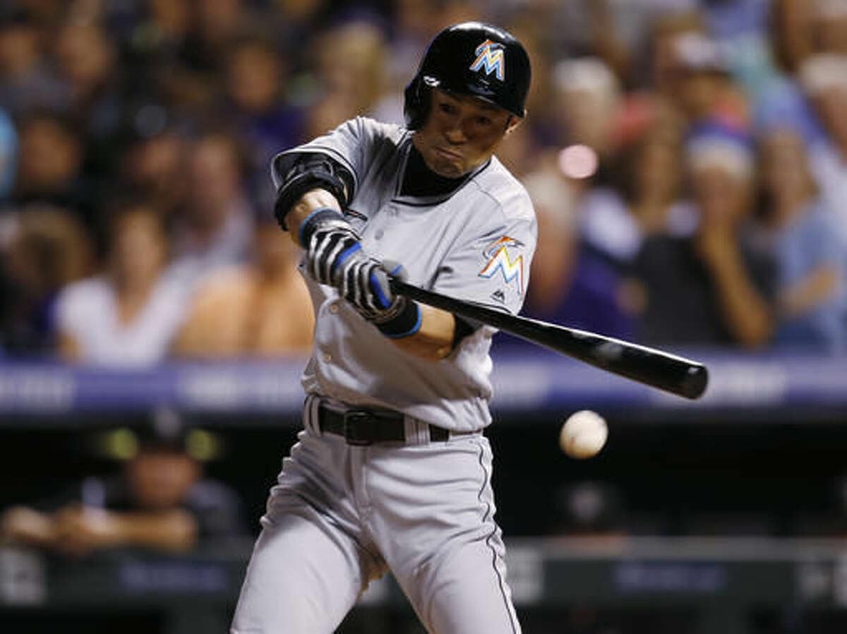 Miami Marlins pinch-hitter Ichiro Suzuki connects for his 2,999th career hit, a single, off Colorado Rockies relief pitcher Jordan Lyles in the eighth inning of a baseball game Saturday, Aug. 6, 2016, in Denver. (AP Photo/David Zalubowski)