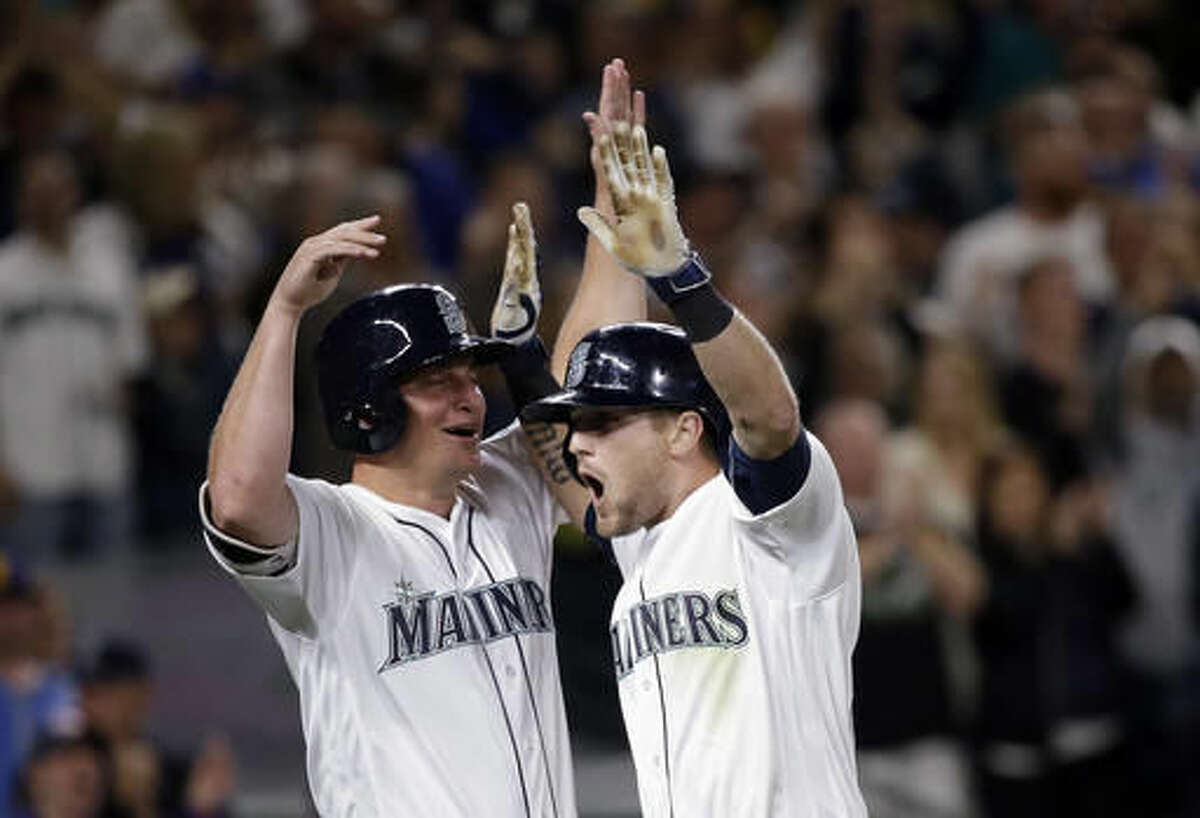 Seattle Mariners' Shawn O'Malley, right, is greeted at home by Kyle Seager after O'Malley's three-run home run against the Los Angeles Angels during the seventh inning of a baseball game Saturday, Aug. 6, 2016, in Seattle. (AP Photo/Elaine Thompson)