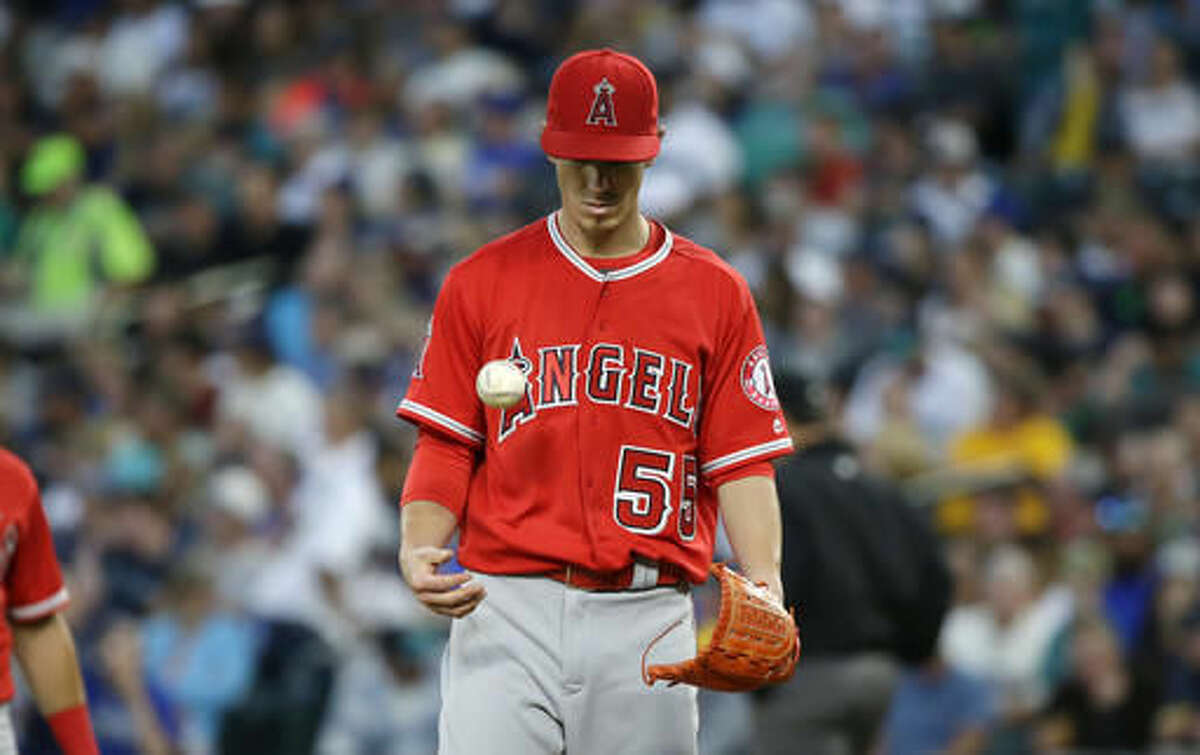 Los Angeles Angels starting pitcher Tim Lincecum tosses the ball as he waits to be pulled in the fourth inning of a baseball game against the Seattle Mariners, Friday, Aug. 5, 2016, in Seattle. (AP Photo/Ted S. Warren)
