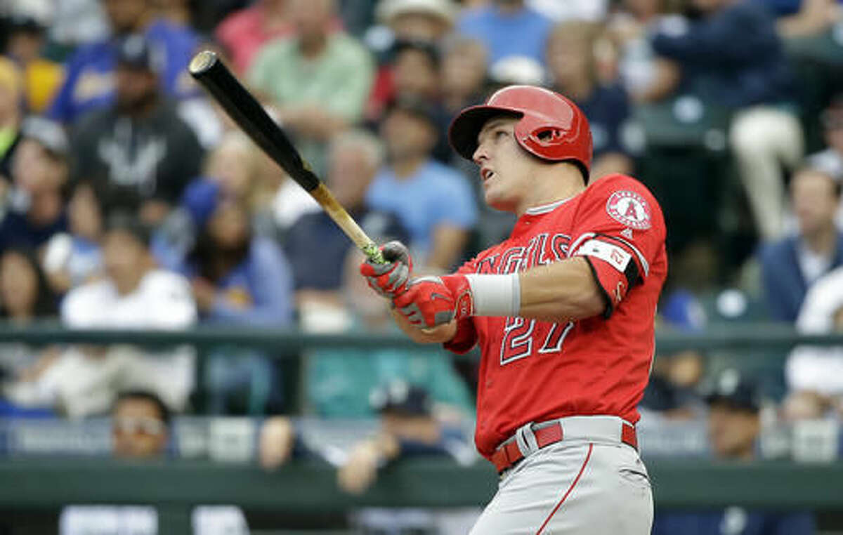 Los Angeles Angels' Mike Trout hits a three-run home run against the Seattle Mariners in the first inning of a baseball game Saturday, Aug. 6, 2016, in Seattle. (AP Photo/Elaine Thompson)