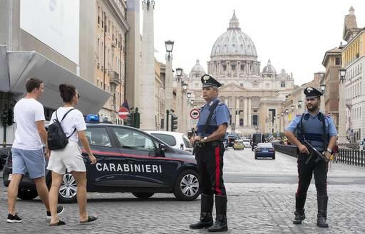 Carabinieri (Italian paramilitary police) officers patrol the area in front of St. Peter's Basilica, visible in background, in Rome, Friday, Aug. 5, 2016. Anti-terrorism measures have been tightened in Rome. They include the stationing of police cars and van at the end of a boulevard that runs past the Colosseum, and police patrols and surveillance along Via del Corso, a long street lined with clothing shops and which also runs by the premier’s office. (Claudio Peri/ANSA via AP)