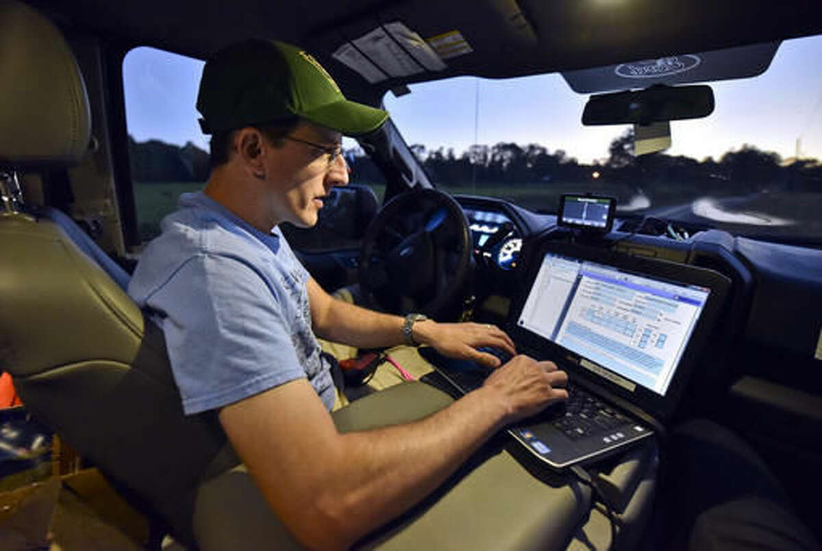 This photo taken July 20, 2016, shows Richard Fritsky, a wildlife diversity biologist for the Pennsylvania Game Commission, setting up his laptop before starting his route for the bat survey in Hop Bottom, Pa. (Jason Farmer /The Citizens' Voice via AP)