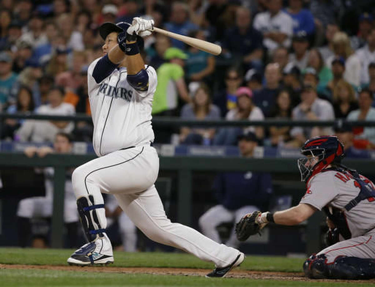 Seattle Mariners' Dae-Ho Lee follows through on an RBI single against the Boston Red Sox during the fifth inning of a baseball game, Thursday, Aug. 4, 2016, in Seattle. (AP Photo/Ted S. Warren)