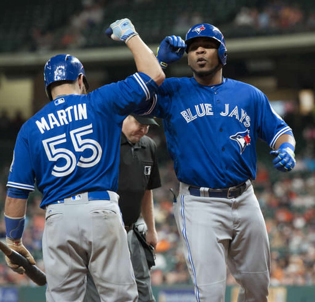 Toronto Blue Jays' Edwin Encarnacion, right, celebrates a solo home run against the Houston Astros with Russell Martin during the ninth inning of a baseball game Thursday, Aug. 4, 2016, in Houston. (AP Photo/George Bridges)