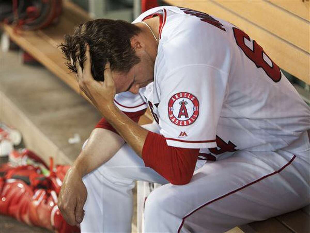 Los Angeles Angels reliever Mike Morin sits in the dugout after giving up two runs to the Oakland Athletics in the 10th inning of a )baseball game Thursday, Aug. 4, 2016, in Anaheim, Calif. The A's won 8-6 in 10 innings. (Kevin Sullivan/The Orange County Register via AP)