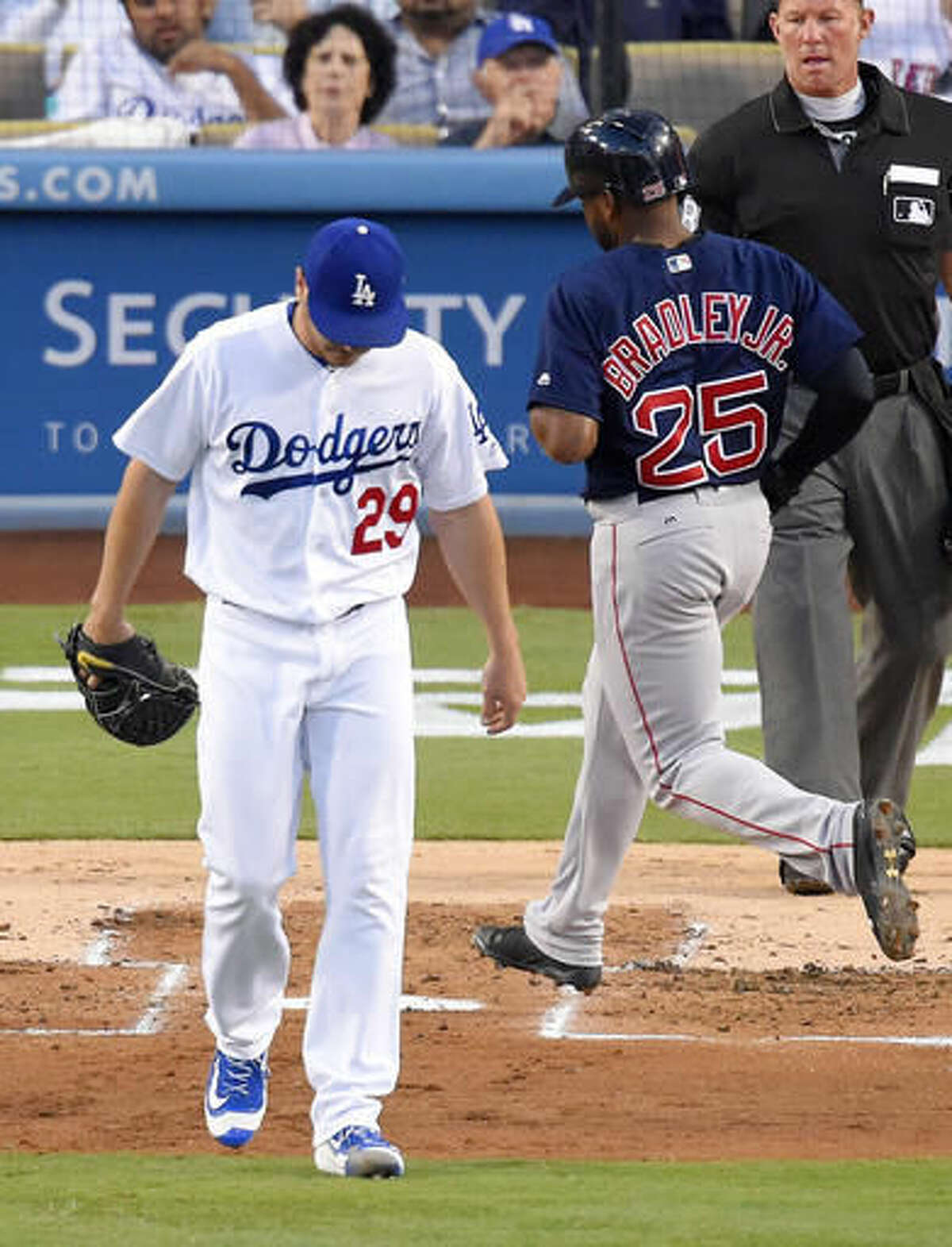 Boston Red Sox's Jackie Bradley Jr., right, scores on a sacrifice fly by Sandy Leon as Los Angeles Dodgers starting pitcher Scott Kazmir walks back to the mound during the second inning of a baseball game, Friday, Aug. 5, 2016, in Los Angeles. (AP Photo/Mark J. Terrill)