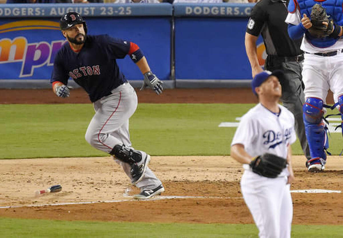 Boston Red Sox's Sandy Leon heads to first on a two-run home run as Los Angeles Dodgers starting pitcher Scott Kazmir watches the ball during the fourth inning of a baseball game, Friday, Aug. 5, 2016, in Los Angeles. (AP Photo/Mark J. Terrill)