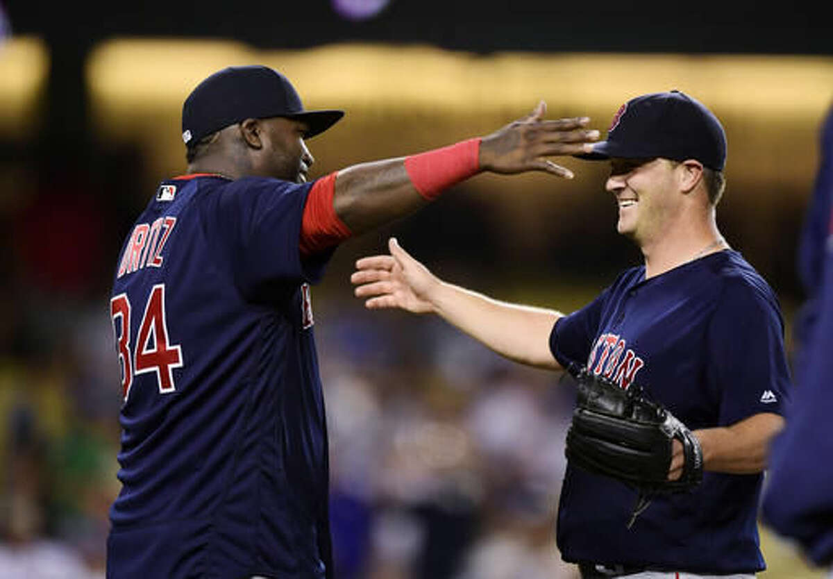 Boston Red Sox's David Ortiz, left, congratulates starting pitcher Steven Wright after the Red Sox defeated the Los Angeles Dodgers 9-0 in a baseball game, Friday, Aug. 5, 2016, in Los Angeles. Wright threw a three-hitter. (AP Photo/Mark J. Terrill)