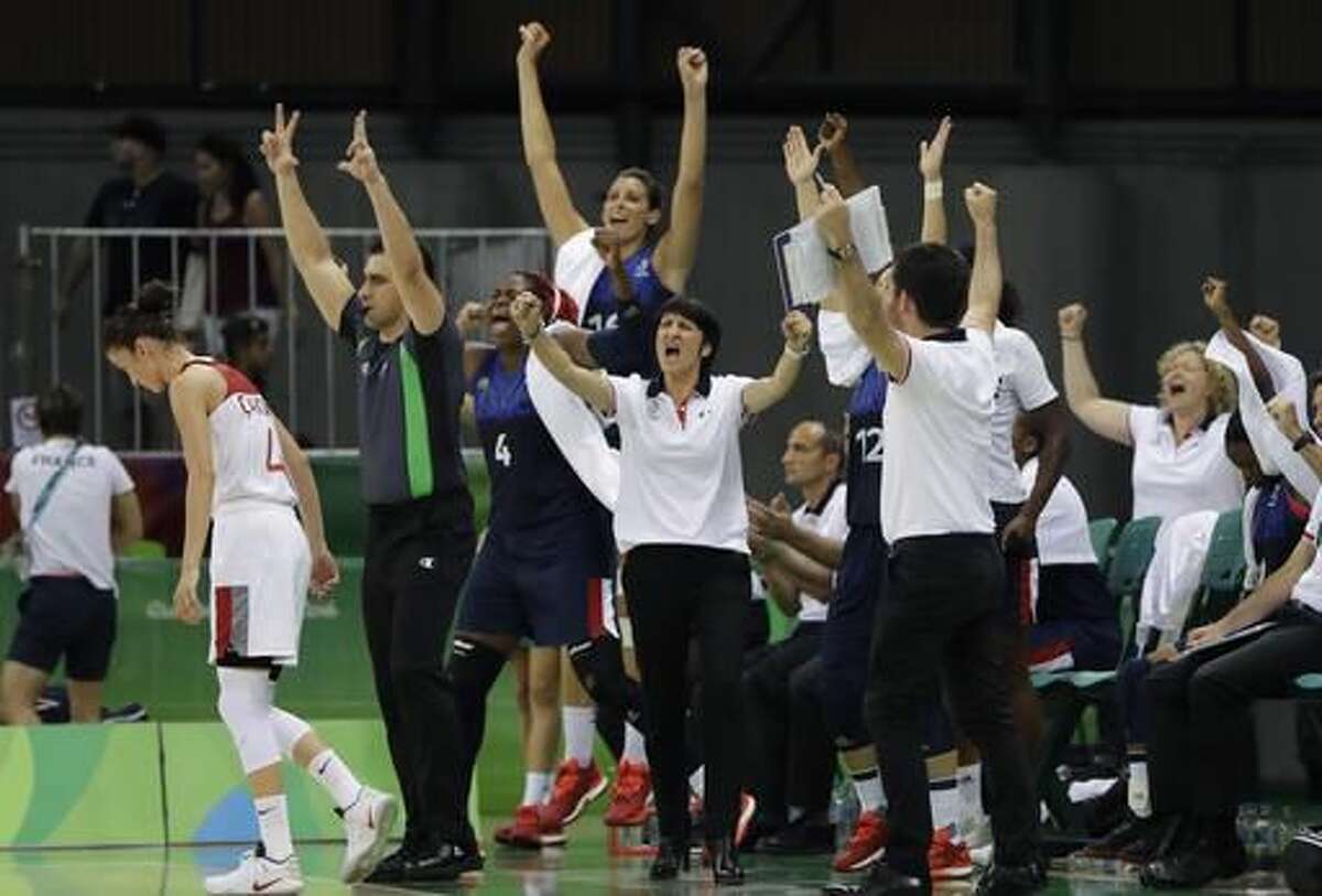France head coach Valerie Garnier and her team react after a three-point basket during the second half of a women's basketball game at the Youth Center at the 2016 Summer Olympics in Rio de Janeiro, Brazil, Saturday, Aug. 6, 2016. France defeated Turkey 55-39. (AP Photo/Carlos Osorio)