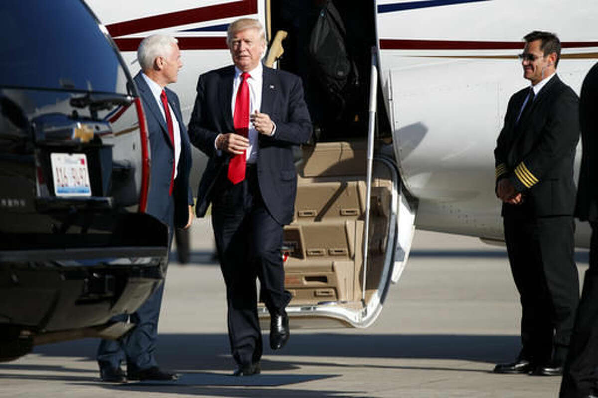 Republican presidential candidate Donald Trump is greeted by vice presidential candidate Gov. Mike Pence, R-Ind., after landing for a campaign rally, Friday, Aug. 5, 2016, in Green Bay, Wis. (AP Photo/Evan Vucci)